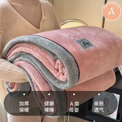 A plush pink and gray fleece blanket with soft texture and branded patch in decorbites cozy cotton velvet style