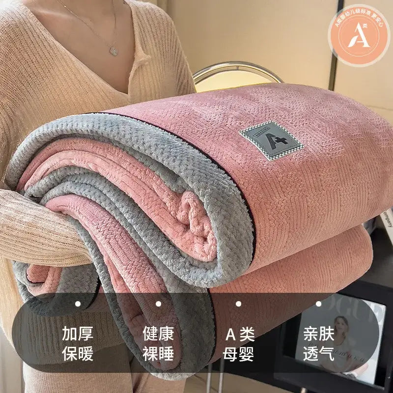 A plush pink and gray fleece blanket with soft texture and branded patch in decorbites cozy cotton velvet style