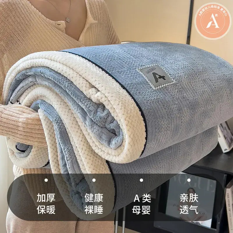 A cozy cotton velvet plush blanket in gray and cream with a soft texture and branded patch for bedroom decorbites