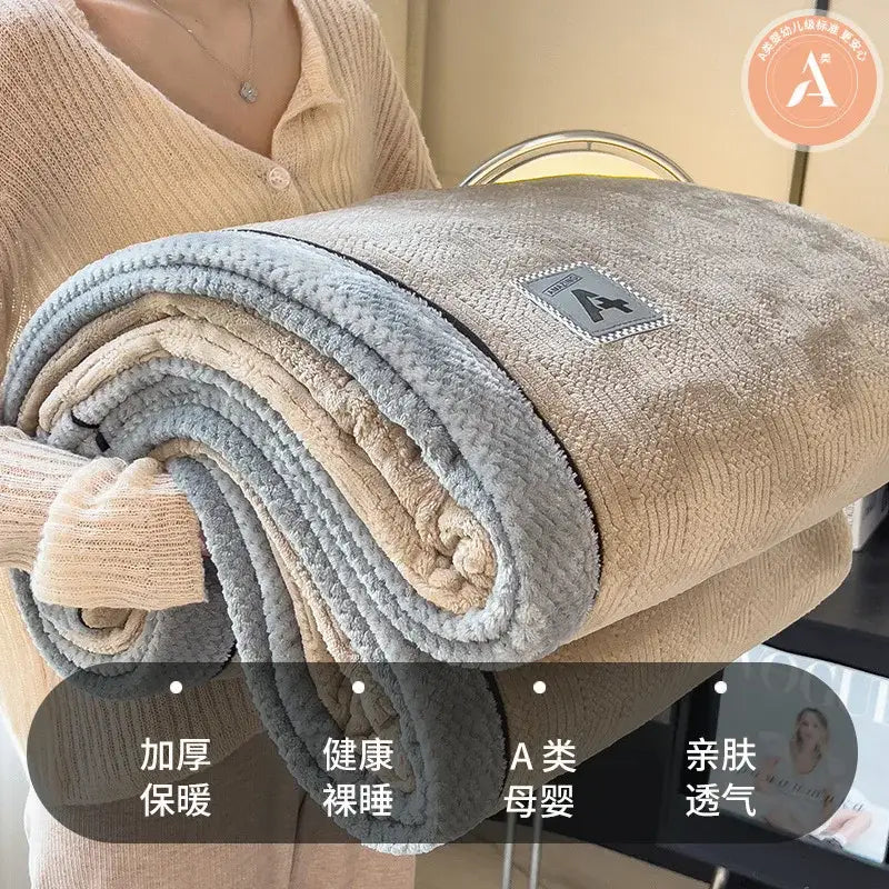 A plush beige and gray rolled-up quilted blanket made of cozy cotton velvet from decorbites cozy cotton collection