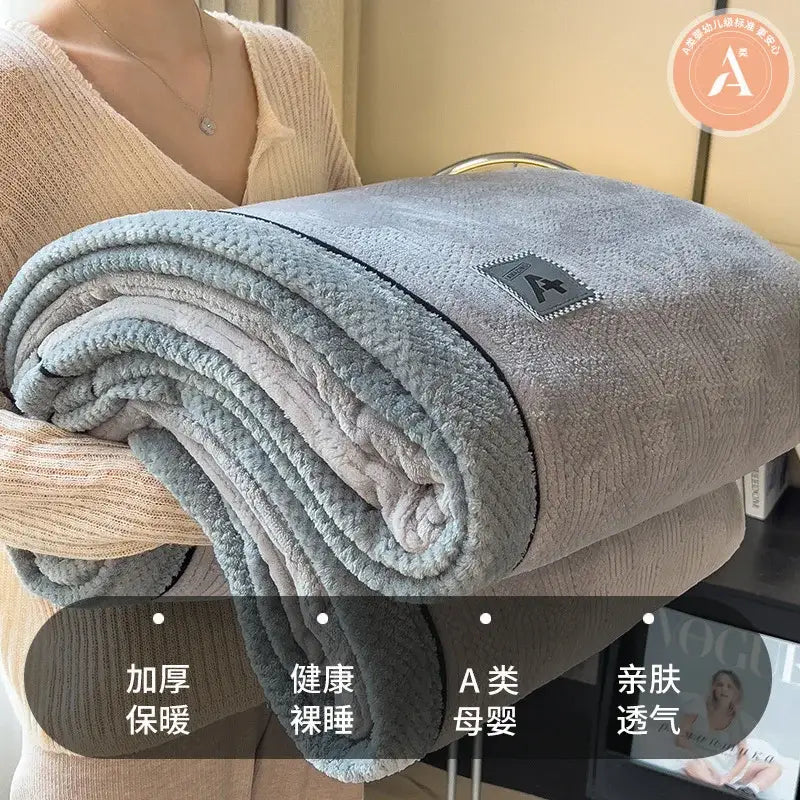 Quilted cream and gray plush blanket made of decorbites cozy cotton velvet with soft texture and stitched border