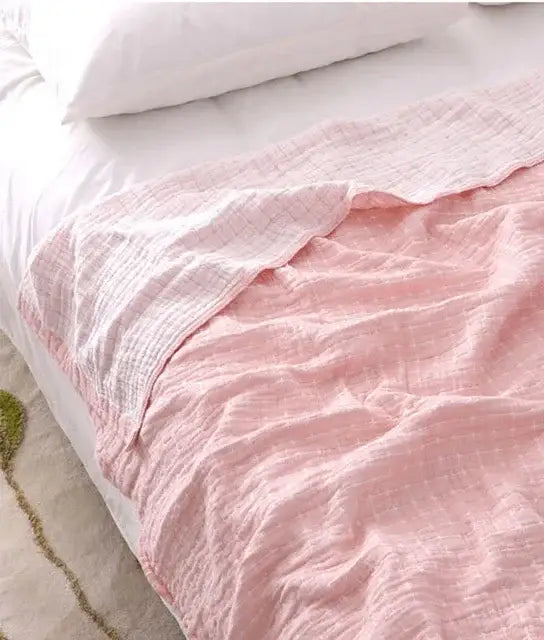 A soft pink textured cotton muslin blanket with subtle grid pattern by decorbites cotton summer for bedroom use
