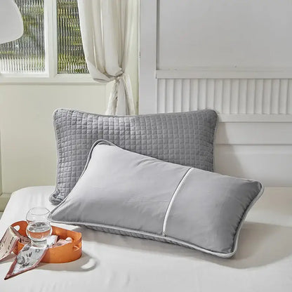 Quilted gray decorbites cotton pillowcase with subtle diamond pattern and white piping for bedroom decor