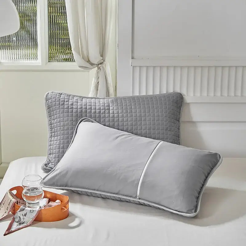 Quilted gray decorbites cotton pillowcase with subtle diamond pattern and white piping for bedroom decor