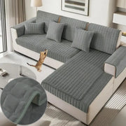 Quilted gray plush sofa cover with soft texture and subtle ribbed stitching for non slip living room use