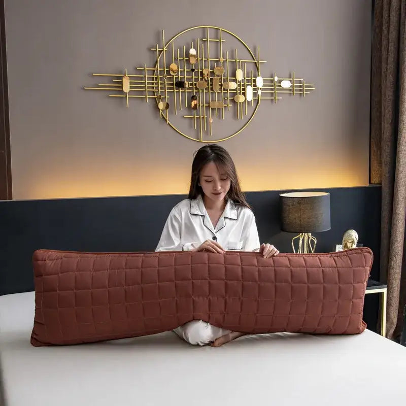 A rust-colored plush quilted body pillow with diamond stitching featuring a decorbites colorful decorative pillowcase cover