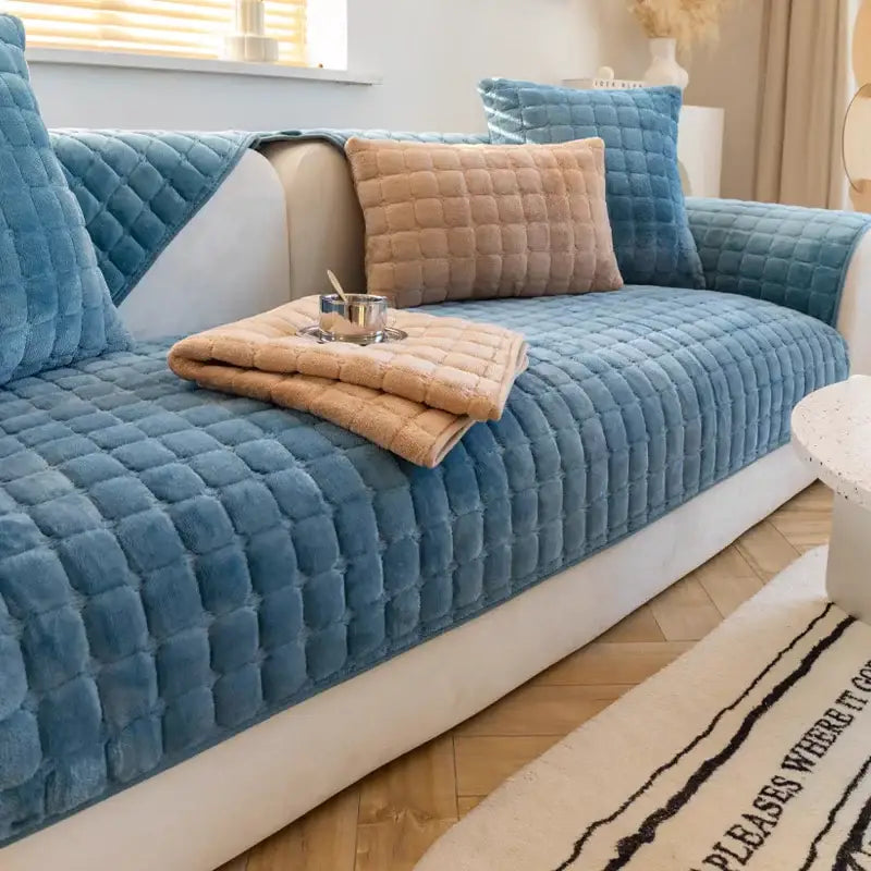 Blue quilted velvet sofa cover with matching cushions and beige throw blanket for gray and tan faux fur living room set