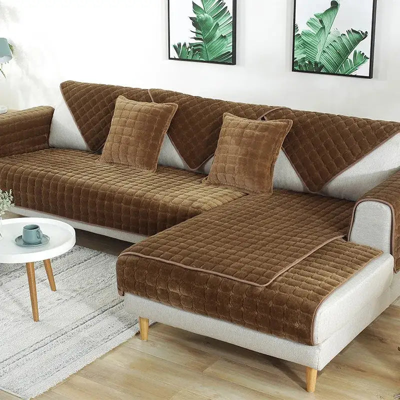 Brown quilted velvet sofa cover with matching throw pillows part of a quilted gray and tan faux fur living room set