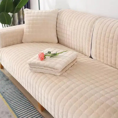 Cream-colored quilted sofa cover with plush texture and diamond-stitched pattern in gray and tan faux fur living room set