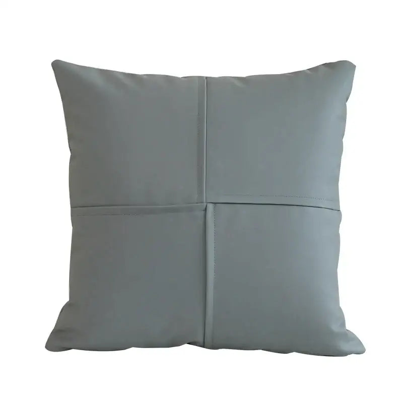 Gray faux leather throw pillow with quilted four-panel design complementing decorbites ivory leather pillow covers