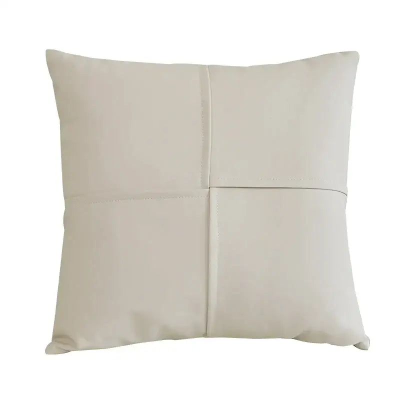 Cream-colored square ivory leather pillow cover with four stitched panels and smooth faux leather texture for decorbites decor