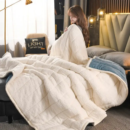 Cream-colored plush quilted bed blanket with blue velvet trim made of decorbites cozy coral fleece for bedroom use