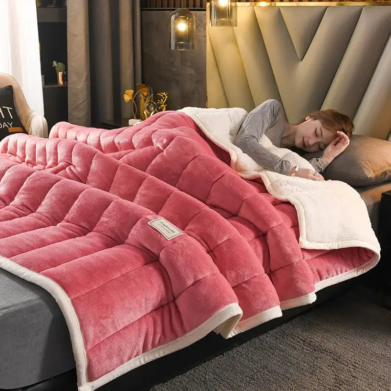 Pink quilted bed blanket with white inner lining and trim made of decorbites cozy coral fleece for bedroom use