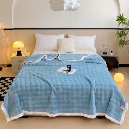 Light blue quilted throw blanket with soft plush texture and white fleece trim made from decorbites imitation rabbit velvet