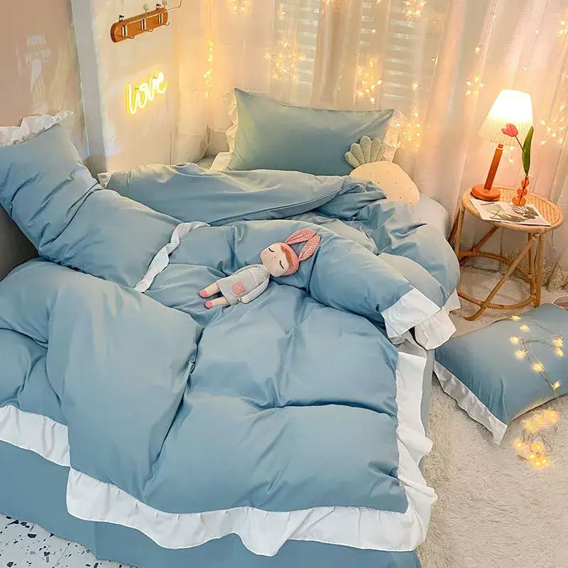 Light blue quilted duvet cover set with white ruffle trim for bedroom bedding with elegant design