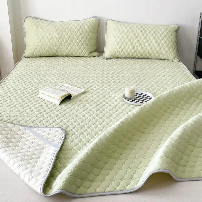 Light green quilted decorbites cooling mat with honeycomb texture and white piping for bedroom bedding use