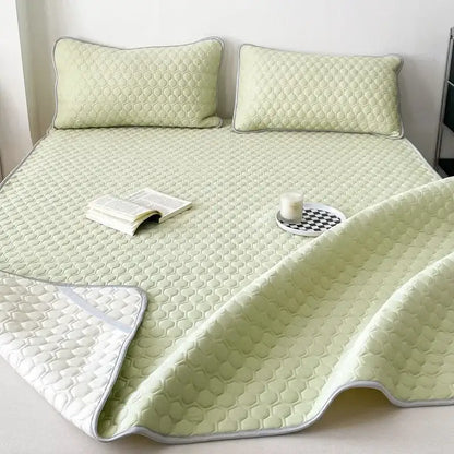 Quilted light green decorbites cooling mat with honeycomb texture and white piping for bedroom bedding set