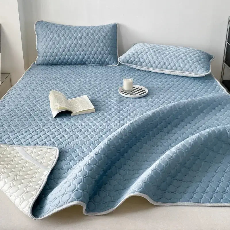 Light blue quilted decorbites cooling mat with honeycomb texture and white piping for bedroom bedding set