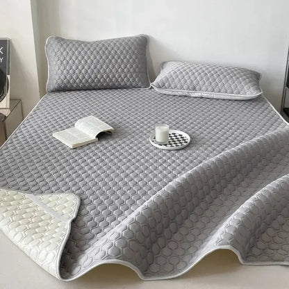 Gray honeycomb-patterned quilted decorbites cooling mat bed pad with white underside for bedroom bedding set