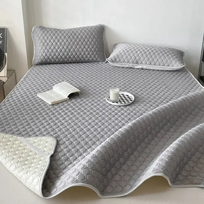 Gray honeycomb-patterned quilted decorbites cooling mat bed pad with white underside for bedroom bedding set