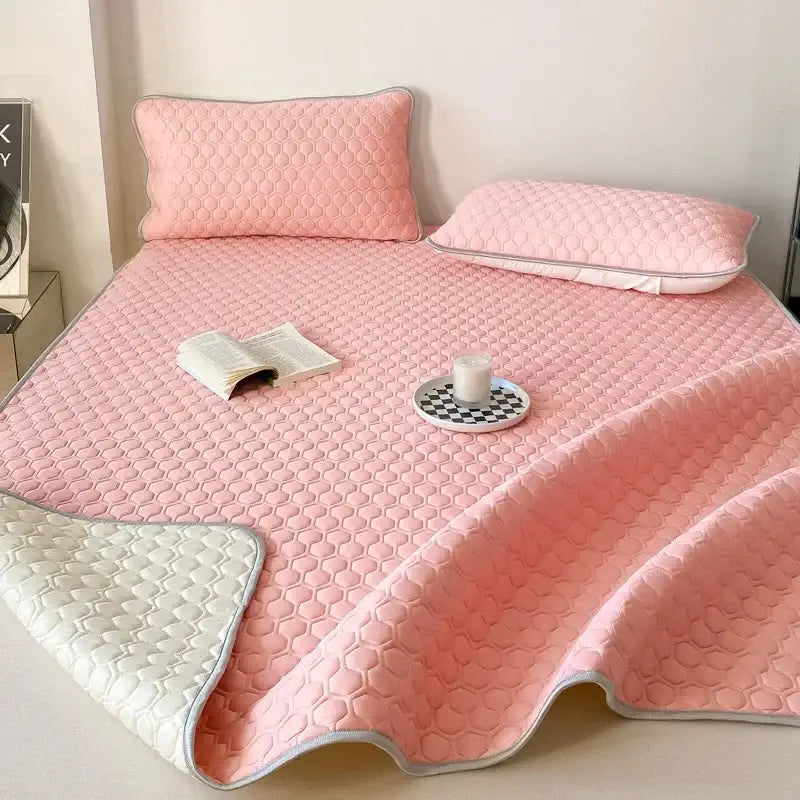 Pink quilted bed pad with honeycomb texture and white trim from decorbites cooling mat bedroom bedding set