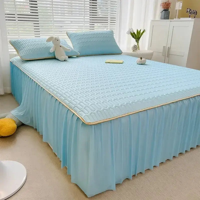 Light blue quilted bed skirt set with gold trim and ruffled skirt complementing a pink bed skirt set with silver trim