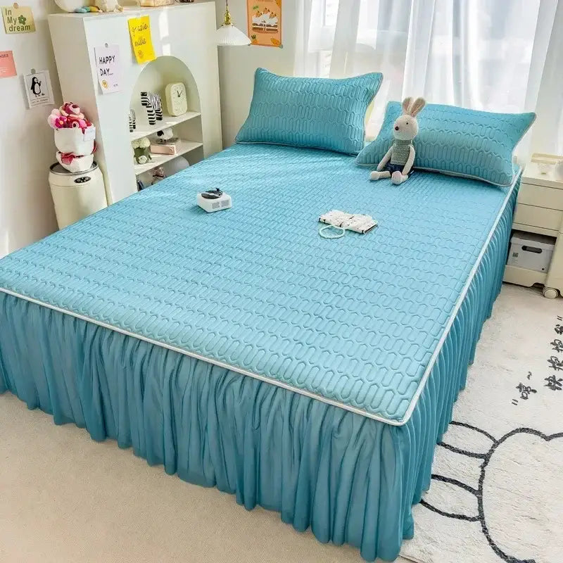 Light blue quilted bed skirt set with ruffled hem and matching pillowcases complementing quilted pink bed skirt with silver trim