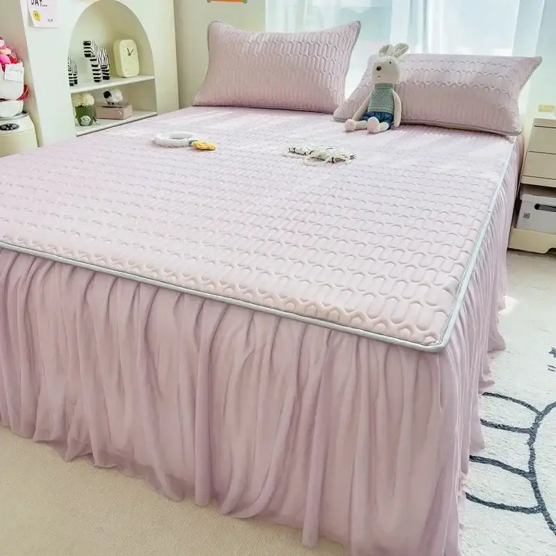 Pink quilted bed skirt set with ruffled skirt and silver trim for bedroom bed pad décor and protection