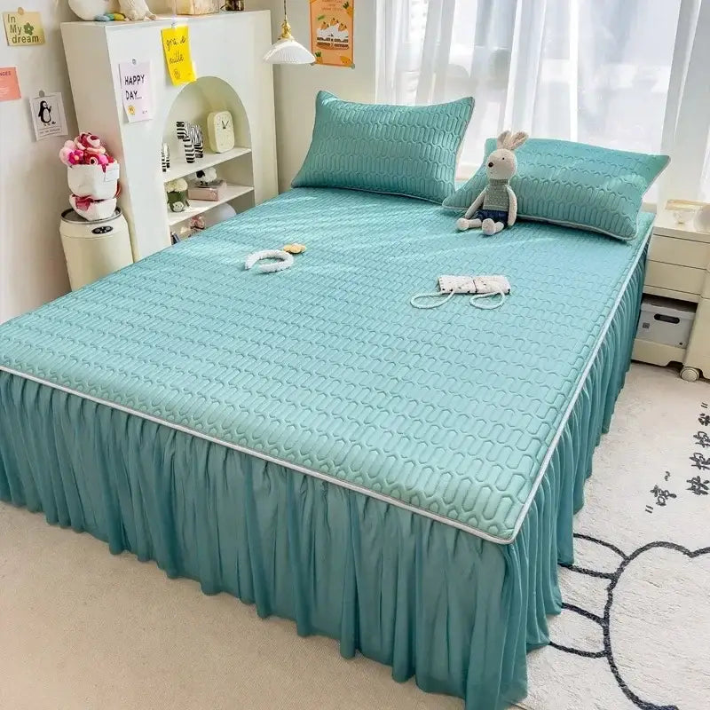 Teal quilted bed skirt set with ruffled skirt and white piping complementing pink bed skirt set with silver trim