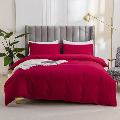 Vibrant red satin duvet cover set with matching pillows and white fringe throw in quilted tan soft bedding cover set