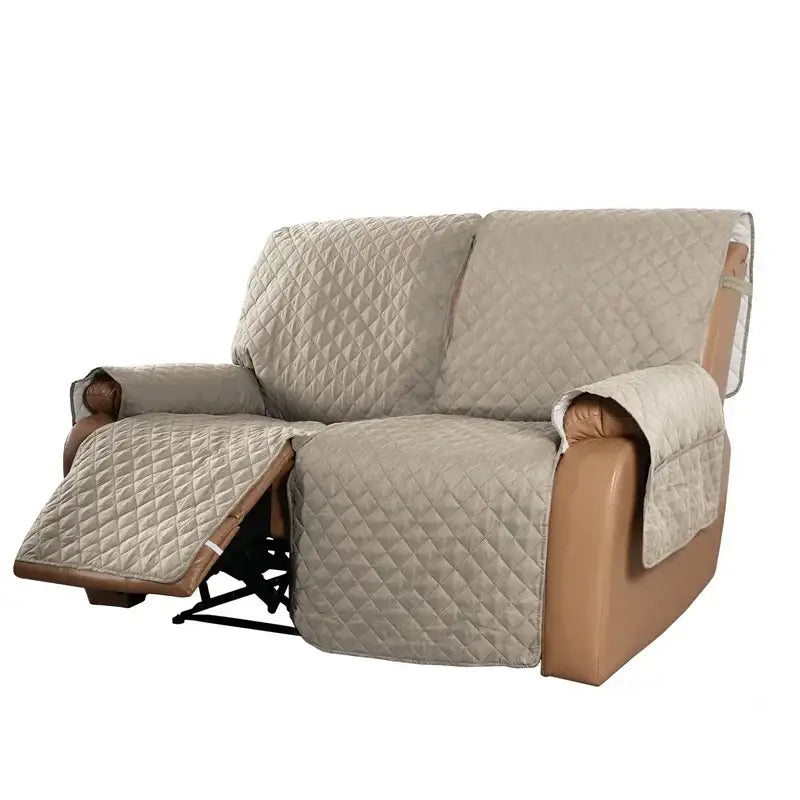 Beige quilted fabric sofa protector with diamond stitching and brown leather trim for recliner slipcover use