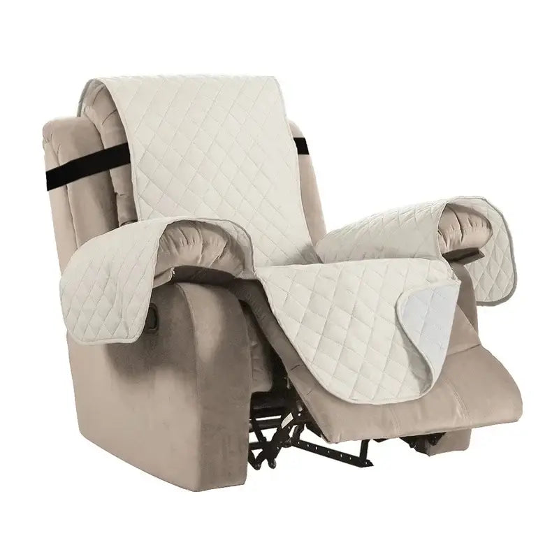 Cream-colored quilted fabric recliner slipcover with black elastic straps for living room chair protection