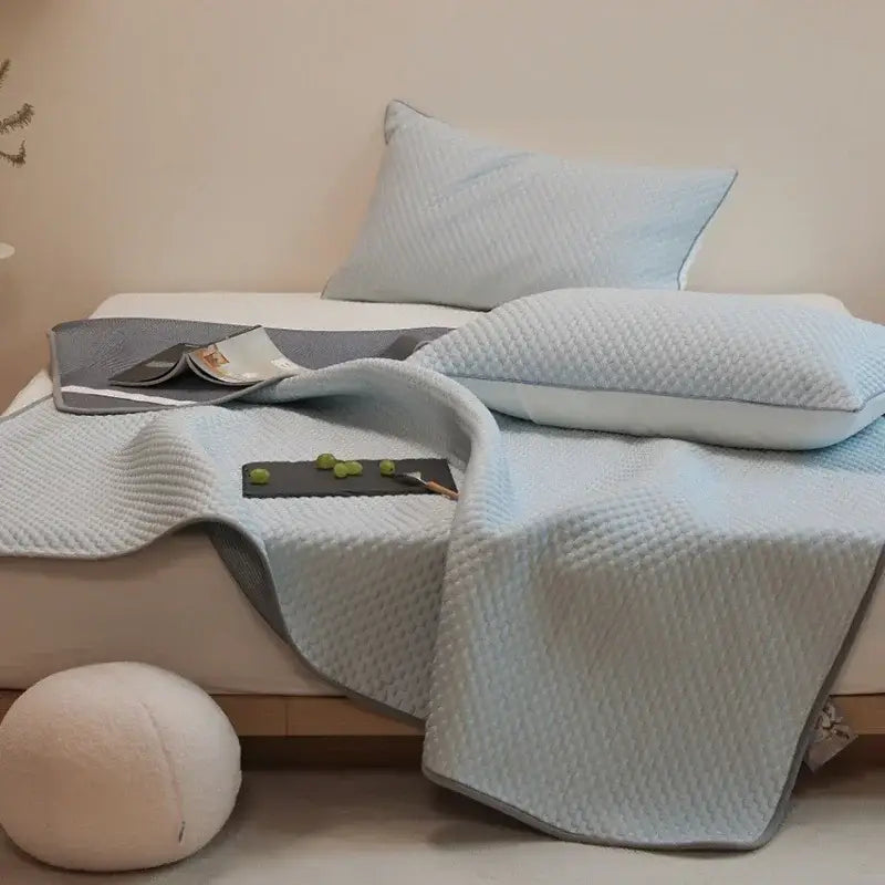 Light blue quilted bedspread with subtle gray border in decorbites ice bean cooling mat pillowcase set