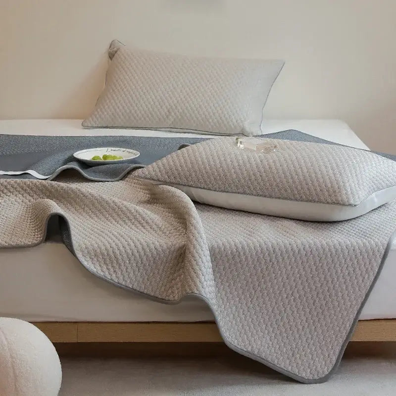 Beige quilted cooling mat with gray border and textured surface from decorbites ice bean pillowcase set