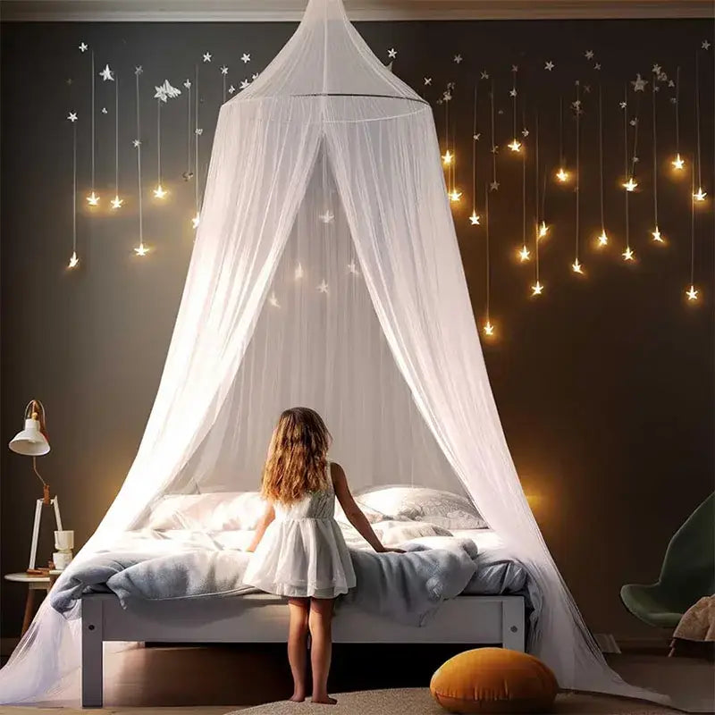 A delicate white sheer hanging mosquito net with star lights flows elegantly above the bed as a bedroom canopy