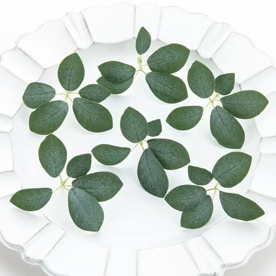 Dark green artificial roses with detailed veining 50pcs silk 5leaf artificial leaves on a white scalloped plate