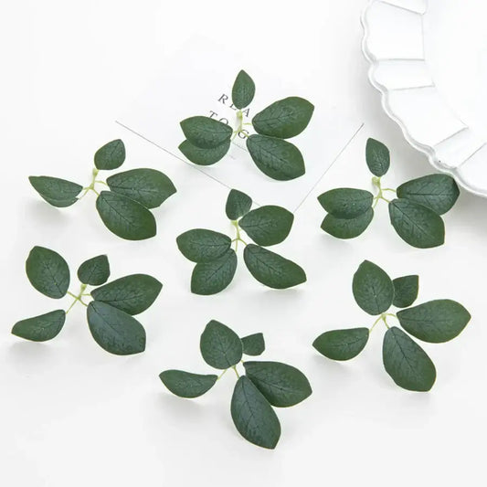Dark green 50pcs silk 5leaf artificial roses with realistic veining and delicate stems arranged on white surface