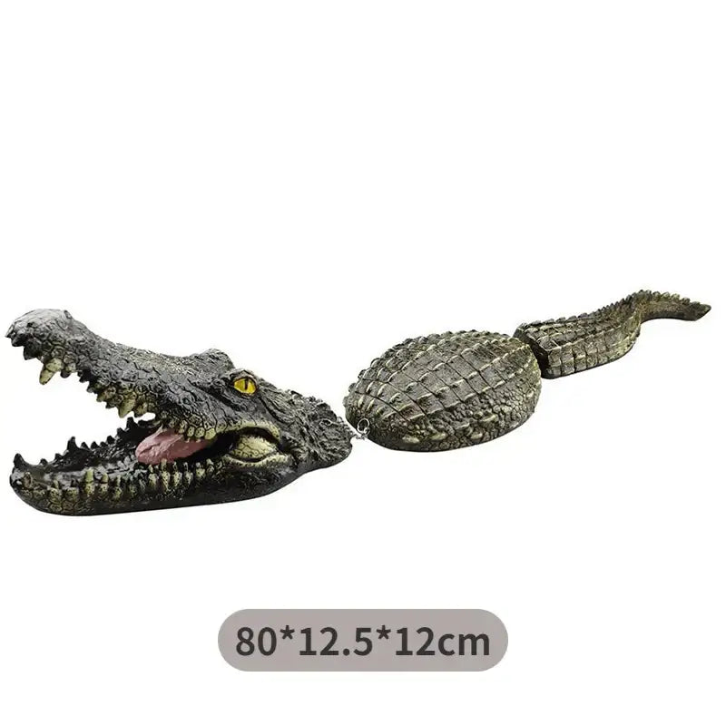Realistic dark green plastic crocodile head decorbites garden water floating animal with textured scales and yellow eyes