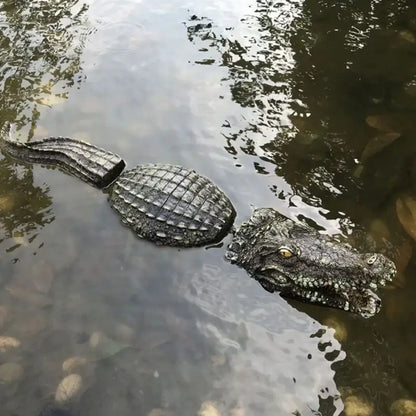 Realistic dark gray plastic crocodile with textured scales partially submerged in water for decorbites garden water use