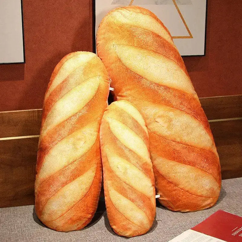 Three plush golden brown and pale yellow decorbites comfort pillows shaped like realistic baguettes for bedroom support