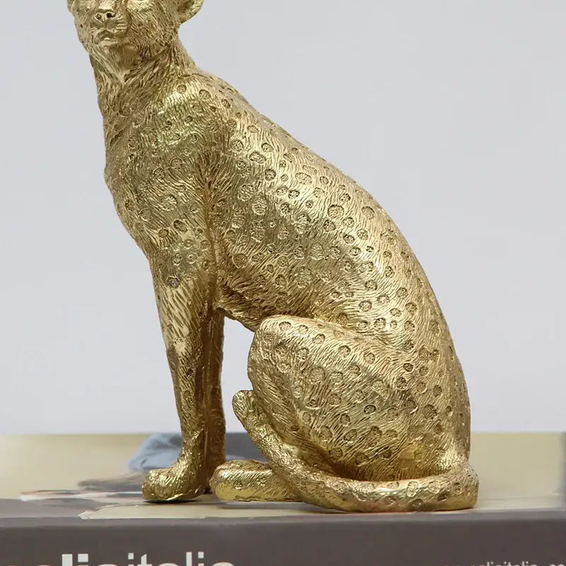 Realistic golden leopard print resin crafts figurine with detailed spotted texture and sleek seated posture for decorbites leopard print decor