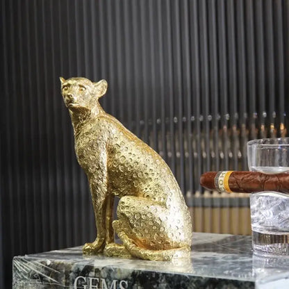 Golden leopard resin crafts figurine with detailed spotted texture sitting poised on marble surface for office decorbites leopard print decor