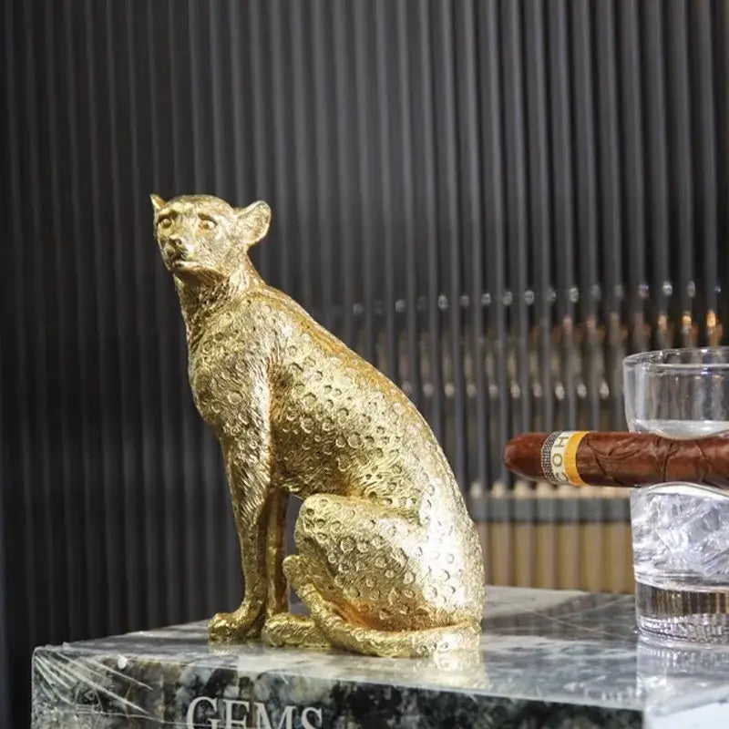 Golden leopard resin crafts figurine with detailed spotted texture sitting poised on marble surface for office decorbites leopard print decor