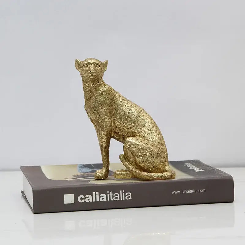 Realistic golden leopard resin crafts figurine with detailed spotted texture sitting poised on a book for office decorbites leopard print decor