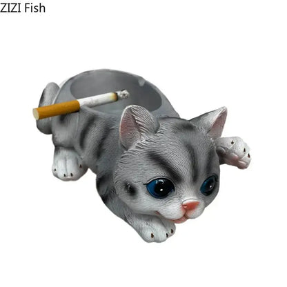Realistic gray cat resin ash tray with blue eyes and pink nose featuring detailed fur texture and cigarette resting on back