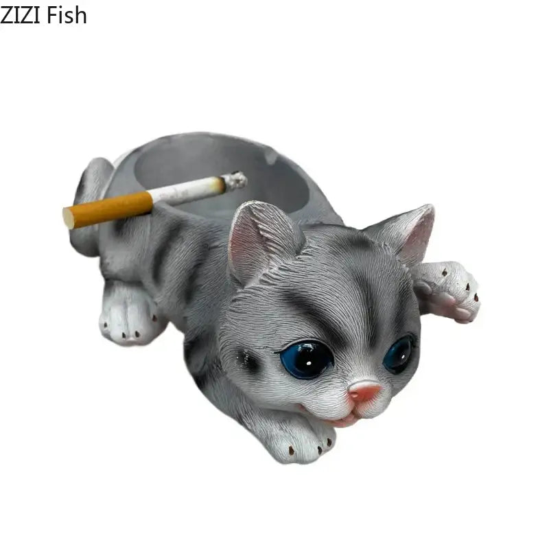 Realistic gray cat resin ash tray with blue eyes and pink nose featuring detailed fur texture and cigarette resting on back