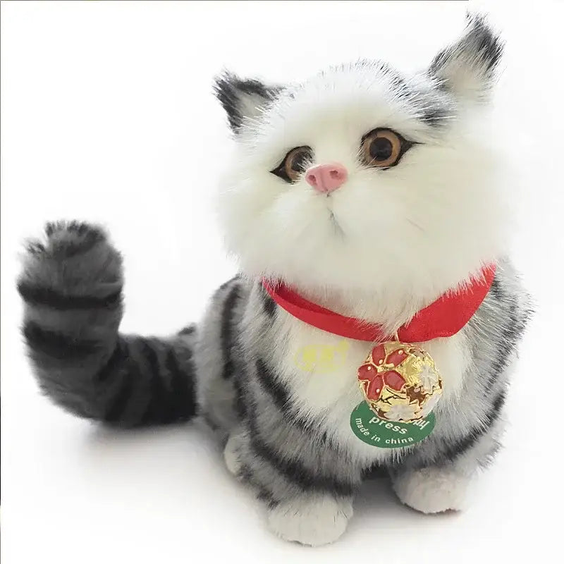 A realistic multi-colored cat dog plush ornament in gray and white with a red collar and gold bell for home decor