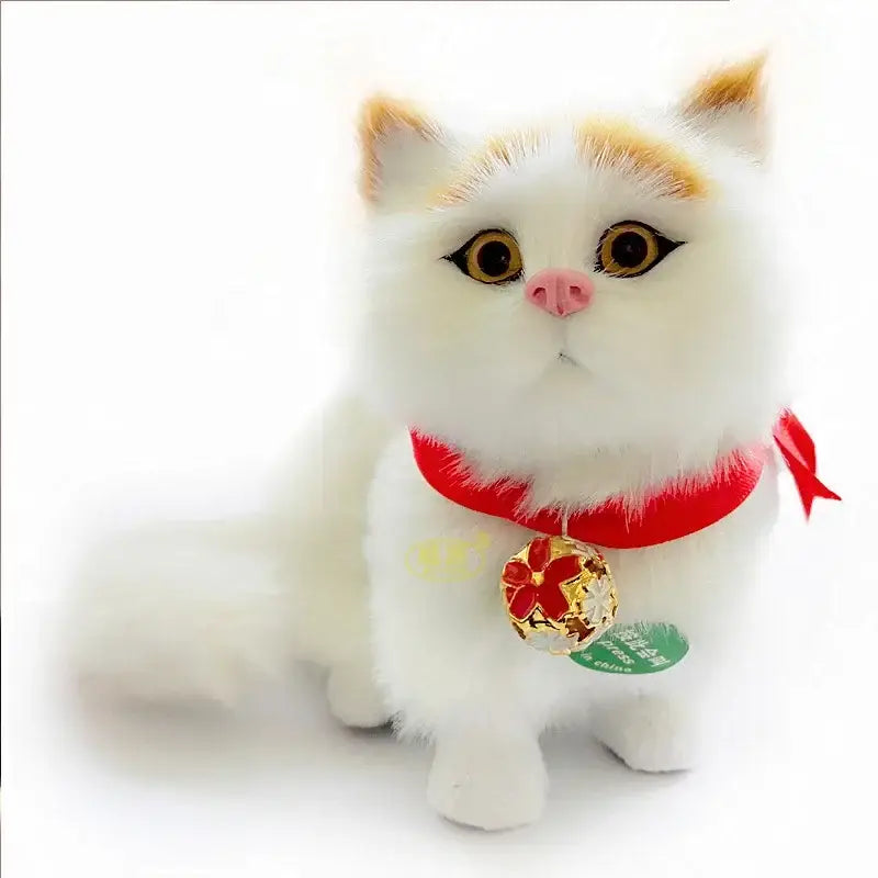 A fluffy white cat dog plush with orange-tipped ears red ribbon collar and gold bell charm for home decor by decorbites