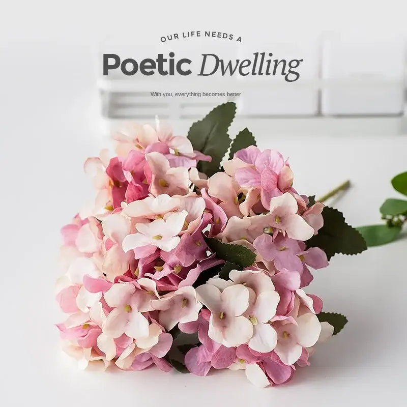 A delicate decorbites hydrangea branch decor with realistic pink and white petals and green leaves for wedding and living room use