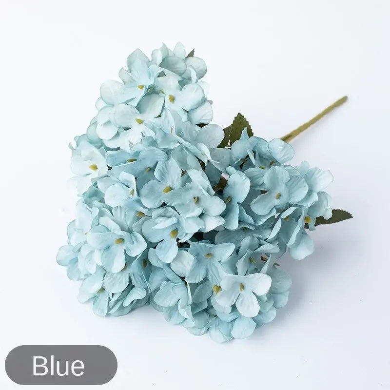 A delicate light blue decorbites hydrangea branch decor with soft petals and yellow centers for wedding or living room use